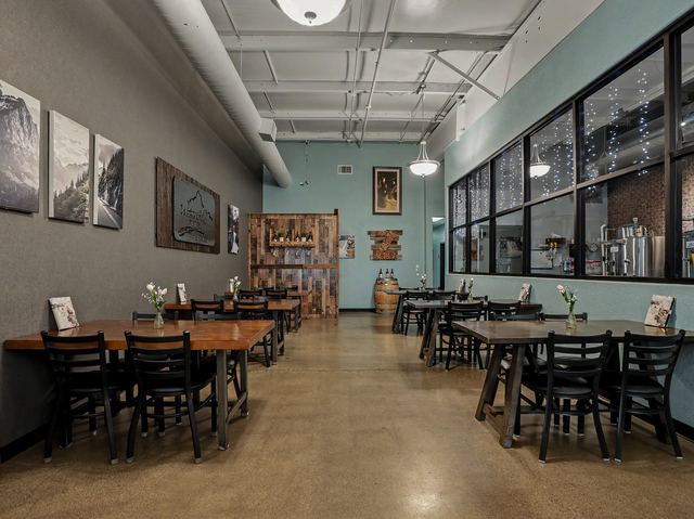 Bistro tables beside the reclaimed wood accent wall