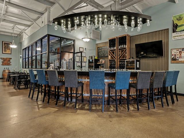 Bar seating beneath the stemware chandelier