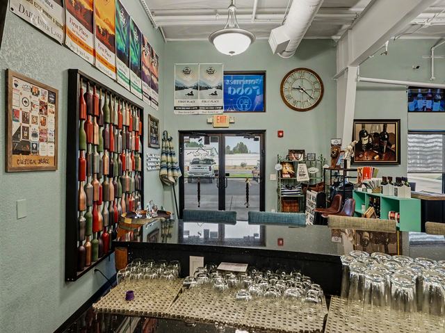 Entry area with colorful bottle wall art and bar top