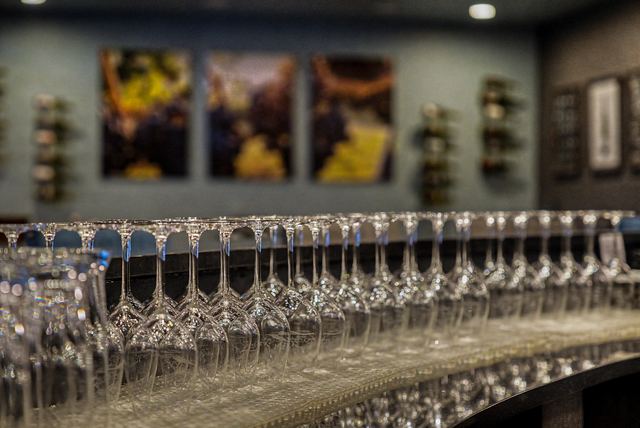 Rows of wine glasses lined up on the bar