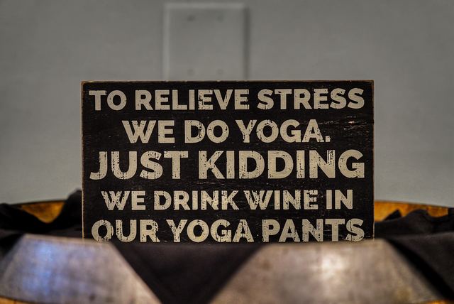Humorous wine sign displayed on a barrel