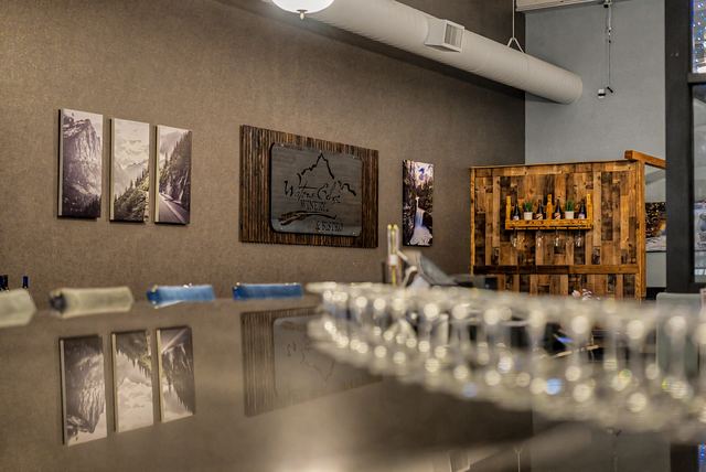Bar top with tasting glasses and the Waters Edge sign