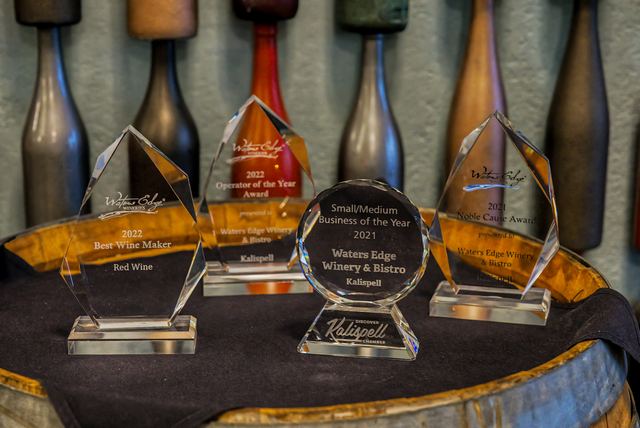 Award trophies displayed on a wine barrel